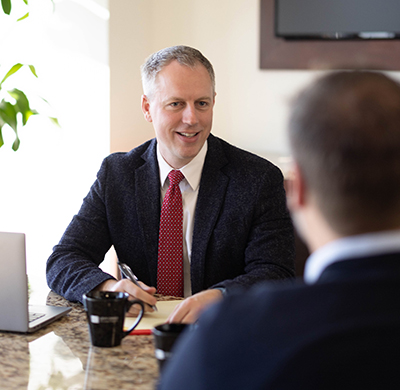 levy craig attorney with client at desk